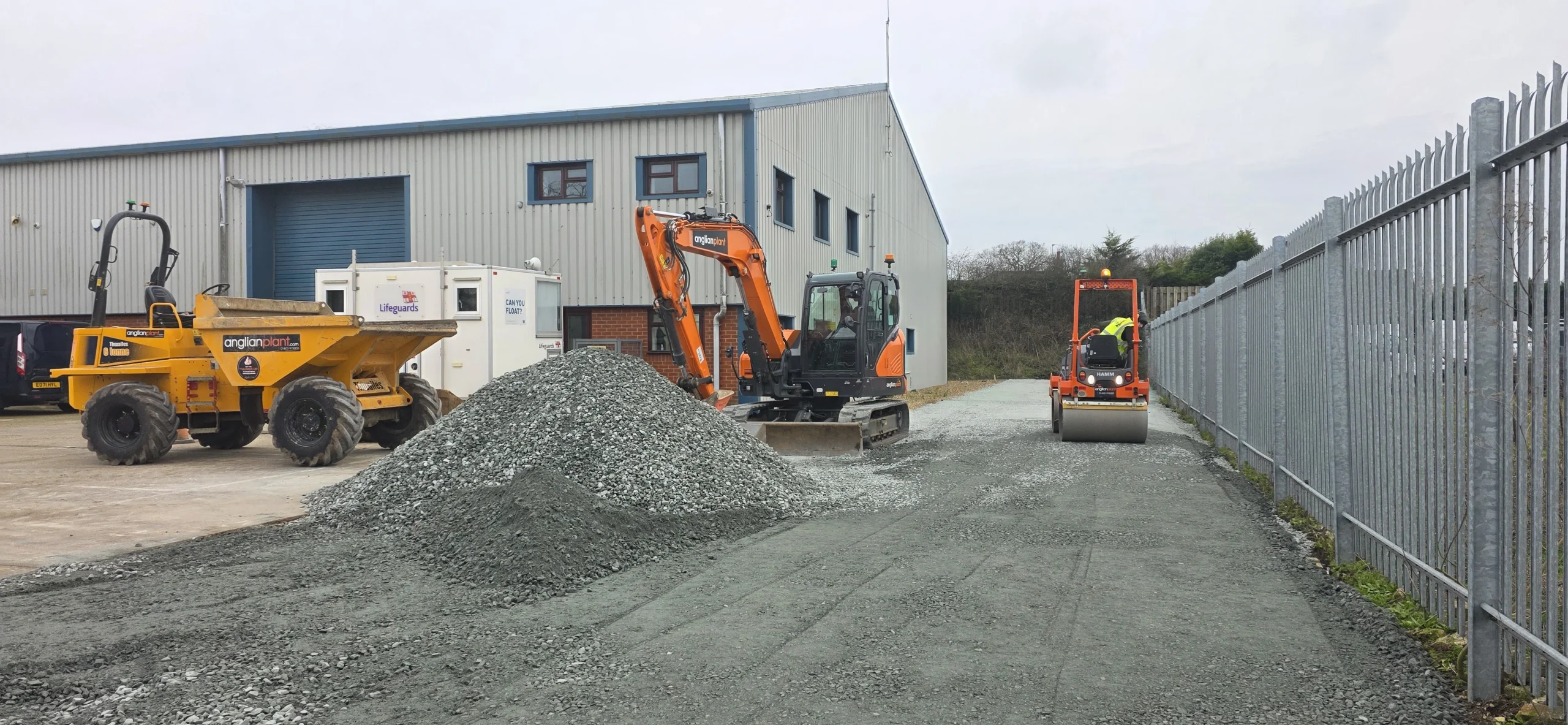 Excavator, roller and dumper constructing a commercial access road at an RNLI site